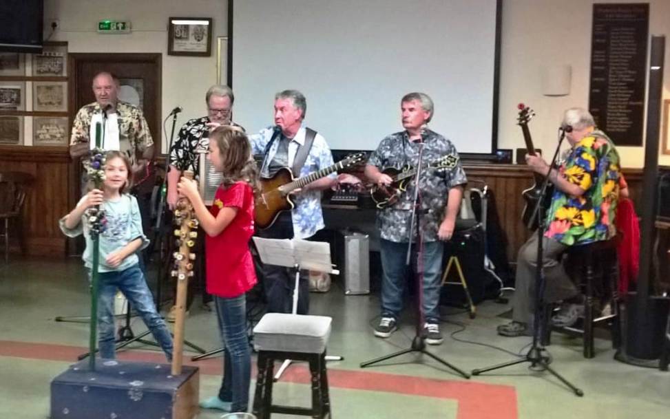 The girls beat time for the Mardi Jug band.